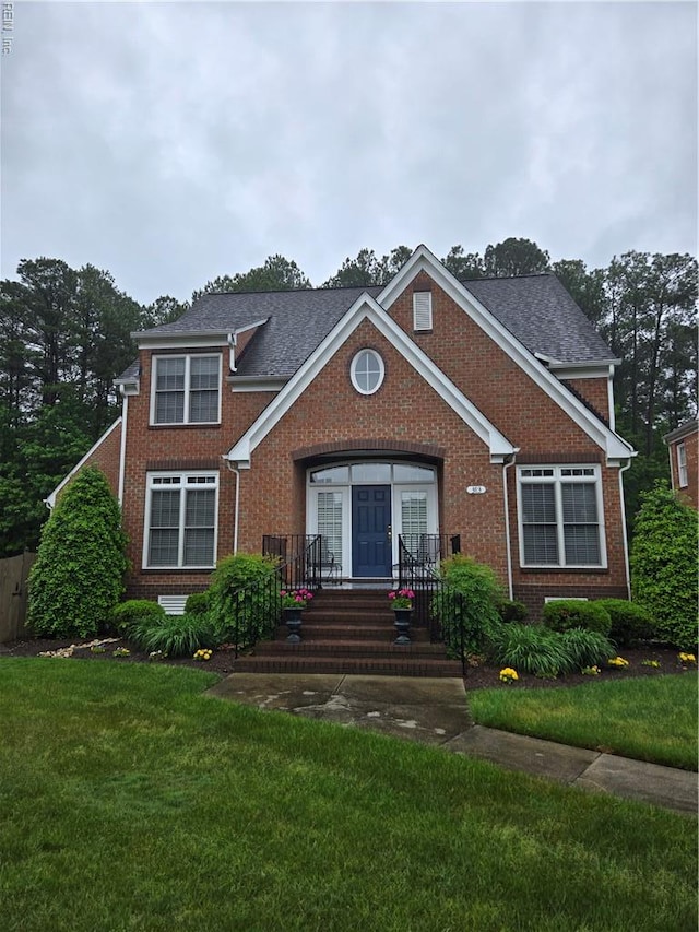 383 Emily Dickinson S, Newport News, VA 23606 - view of front of property with brick siding, a front lawn, and roof with shingles