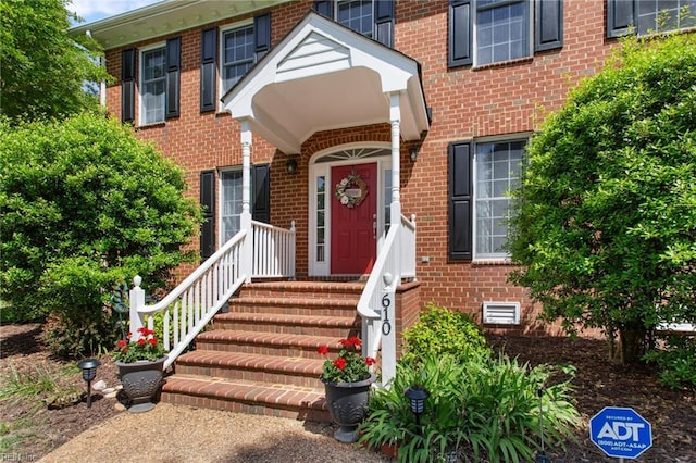 property entrance featuring brick siding