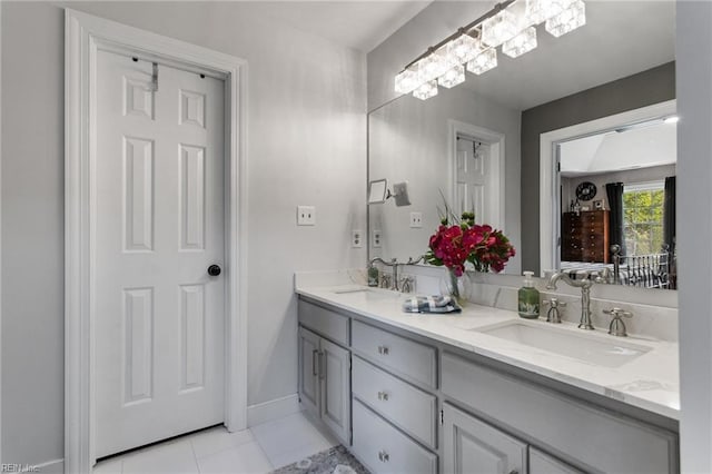 full bathroom featuring double vanity, tile patterned floors, and baseboards