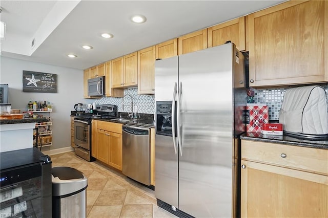 1222 E Ocean View Ave Unit 302, Norfolk, VA 23503 - kitchen featuring appliances with stainless steel finishes, a sink, dark countertops, recessed lighting, and backsplash
