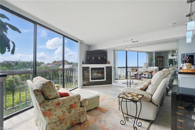 1222 E Ocean View Ave Unit 302, Norfolk, VA 23503 - tiled living room with a textured ceiling, a glass covered fireplace, and expansive windows
