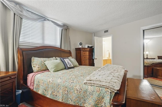 1222 E Ocean View Ave Unit 302, Norfolk, VA 23503 - bedroom featuring a textured ceiling and ensuite bathroom