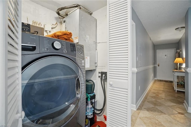 1222 E Ocean View Ave Unit 302, Norfolk, VA 23503 - laundry area with washer / dryer, baseboards, and stone finish flooring