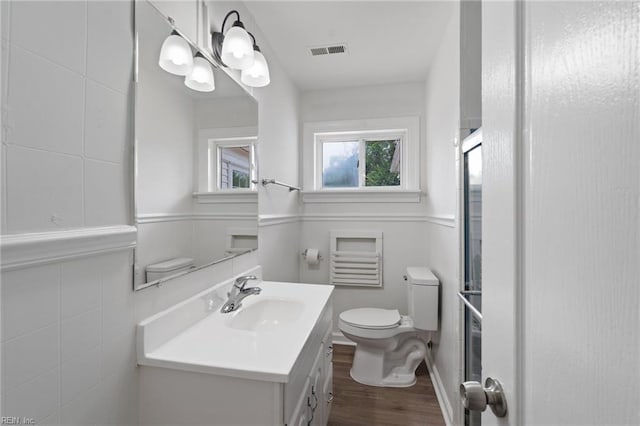 669 Kenneth Rd, Virginia Beach, VA 23462 - bathroom with wood finished floors, vanity, toilet, and a shower with door