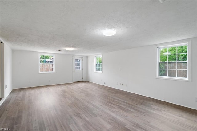 669 Kenneth Rd, Virginia Beach, VA 23462 - unfurnished room featuring a textured ceiling, wood finished floors, and plenty of natural light