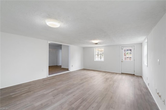 669 Kenneth Rd, Virginia Beach, VA 23462 - empty room featuring a textured ceiling, wood finished floors, and baseboards