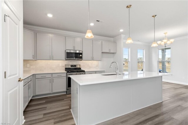 2237 Sanibel Ln, Chesapeake, VA 23321 - kitchen featuring a sink, stainless steel appliances, backsplash, ornamental molding, and wood finished floors
