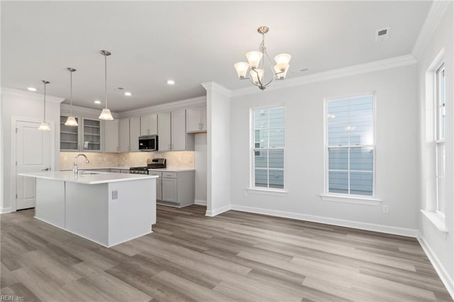 2237 Sanibel Ln, Chesapeake, VA 23321 - kitchen featuring appliances with stainless steel finishes, gray cabinetry, a chandelier, tasteful backsplash, and ornamental molding