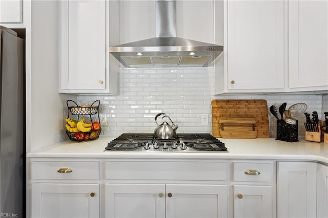 2316 William D Lee Ct, Virginia Beach, VA 23456 - kitchen with stainless steel gas cooktop, wall chimney exhaust hood, refrigerator, white cabinetry, and tasteful backsplash