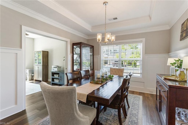 2316 William D Lee Ct, Virginia Beach, VA 23456 - dining area with a chandelier, a decorative wall, a tray ceiling, dark wood-style floors, and wainscoting