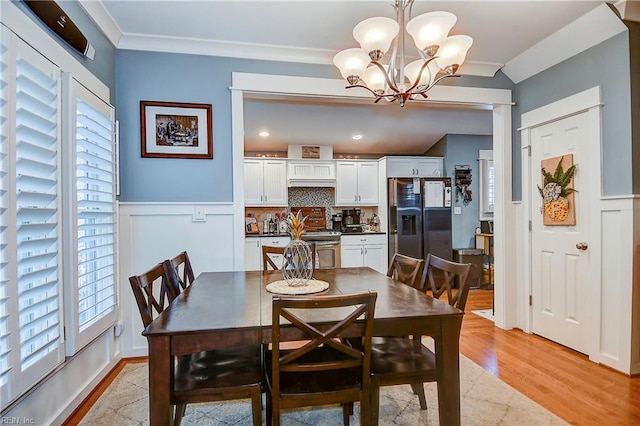9527 24th Bay St, Norfolk, VA 23518 - dining area with ornamental molding, a chandelier, light wood-type flooring, and a wainscoted wall