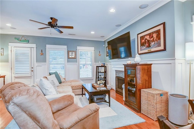 9527 24th Bay St, Norfolk, VA 23518 - living room featuring light wood-style flooring, a wainscoted wall, crown molding, ceiling fan, and a decorative wall