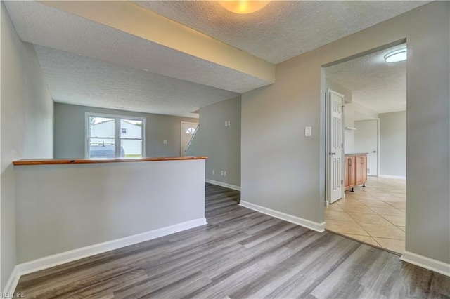 913 Fluvanna Rd, Newport News, VA 23601 - spare room with a textured ceiling, wood finished floors, and baseboards