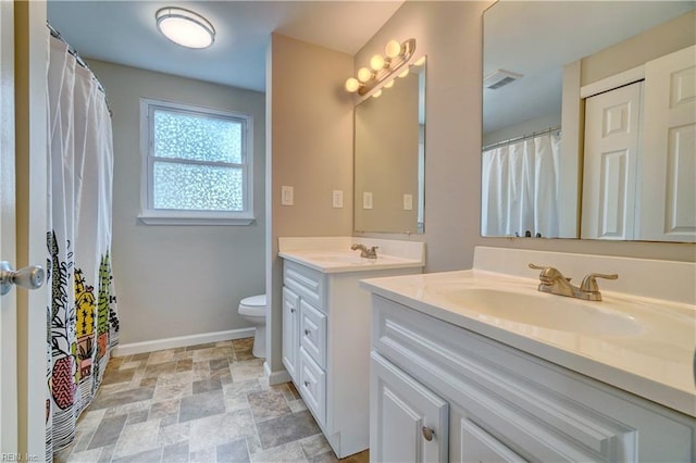913 Fluvanna Rd, Newport News, VA 23601 - bathroom featuring vanity, baseboards, toilet, and stone finish flooring