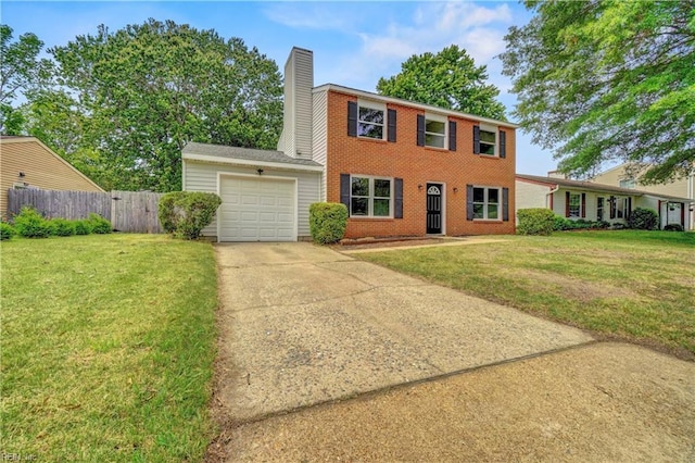 913 Fluvanna Rd, Newport News, VA 23601 - colonial-style house with an attached garage, driveway, brick siding, and a chimney
