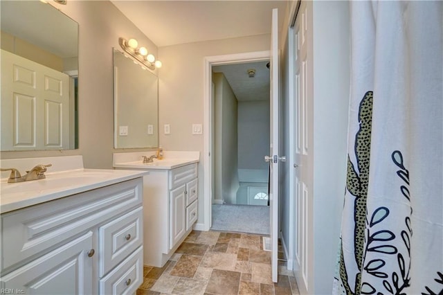 913 Fluvanna Rd, Newport News, VA 23601 - full bath with two vanities, stone finish floors, and baseboards