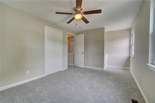 913 Fluvanna Rd, Newport News, VA 23601 - unfurnished bedroom featuring carpet, a textured ceiling, a closet, baseboards, and a ceiling fan