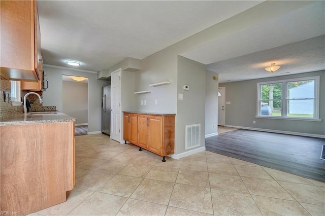 913 Fluvanna Rd, Newport News, VA 23601 - kitchen with stainless steel fridge, light tile patterned flooring, a sink, baseboards, and open shelves