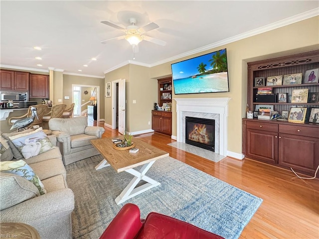 564 Riverside Dr, Lancaster, VA 22503 - living area with light wood-style flooring, ornamental molding, ceiling fan, a fireplace, and baseboards