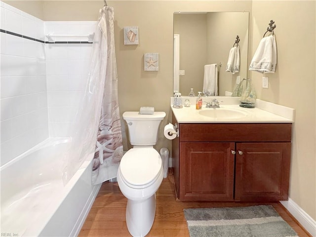 564 Riverside Dr, Lancaster, VA 22503 - full bathroom with toilet, shower / tub combo with curtain, vanity, wood finished floors, and baseboards