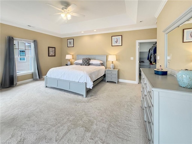 564 Riverside Dr, Lancaster, VA 22503 - bedroom featuring a tray ceiling, light carpet, baseboards, crown molding, and a spacious closet
