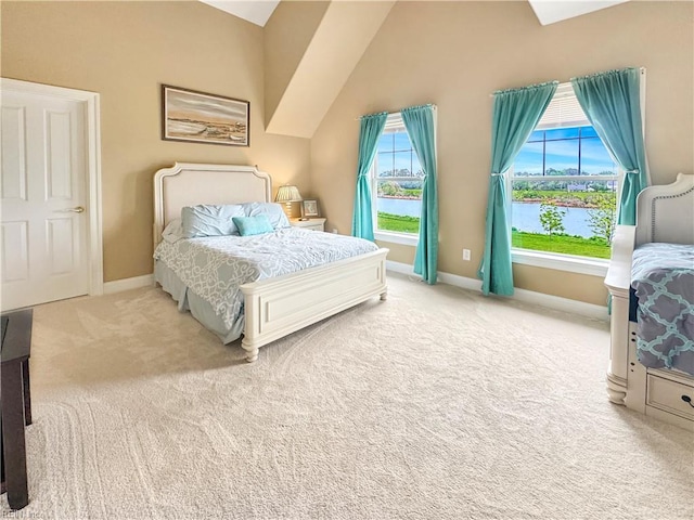 564 Riverside Dr, Lancaster, VA 22503 - carpeted bedroom featuring lofted ceiling, baseboards, and a water view
