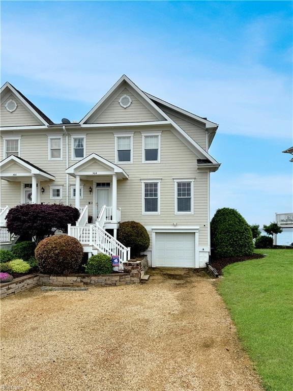 564 Riverside Dr, Lancaster, VA 22503 - view of front facade with a garage and dirt driveway