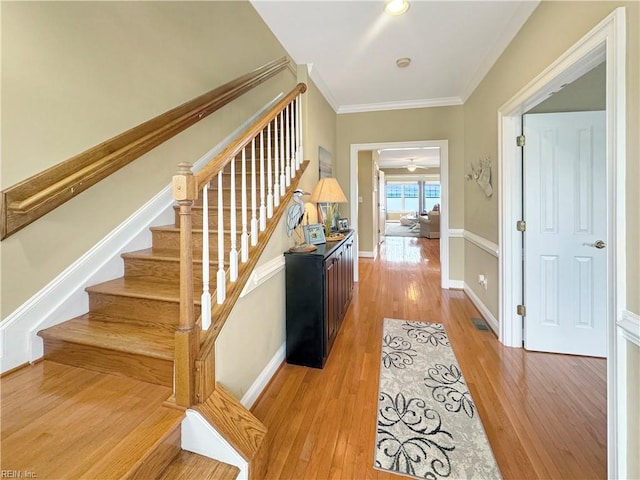 564 Riverside Dr, Lancaster, VA 22503 - hallway with light wood finished floors, ornamental molding, stairs, and baseboards