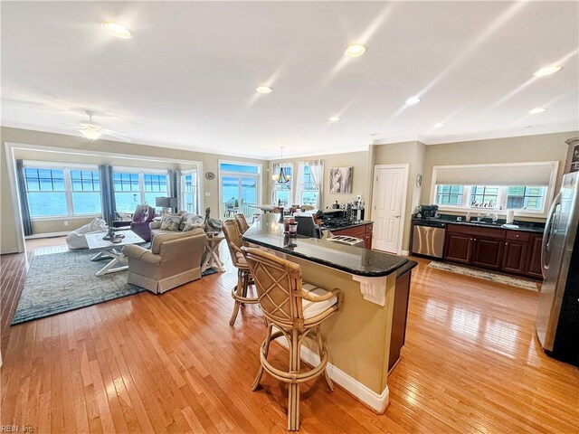 564 Riverside Dr, Lancaster, VA 22503 - kitchen featuring appliances with stainless steel finishes, light wood-style floors, a breakfast bar, plenty of natural light, and recessed lighting