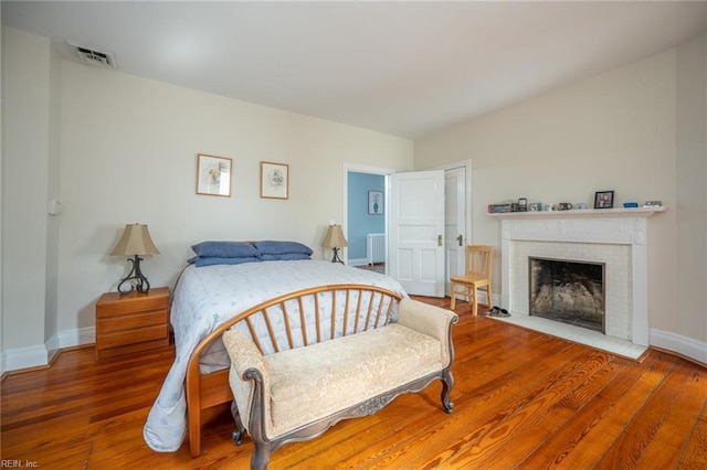 502 Pembroke Ave, Norfolk, VA 23507 - bedroom with baseboards, wood finished floors, and a fireplace
