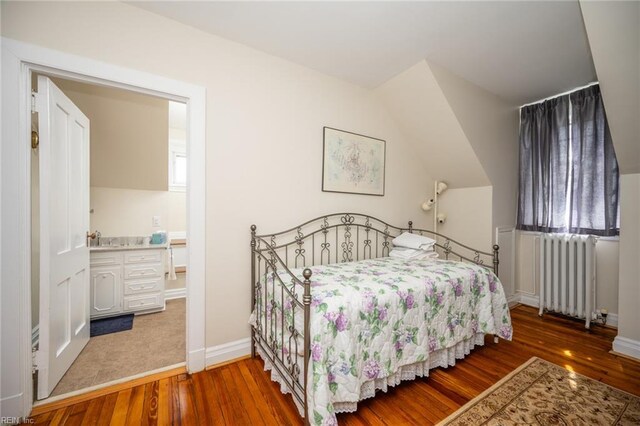 502 Pembroke Ave, Norfolk, VA 23507 - bedroom featuring radiator, wood finished floors, baseboards, and ensuite bath