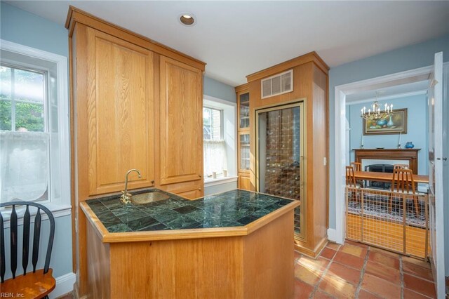 502 Pembroke Ave, Norfolk, VA 23507 - kitchen featuring tile counters, a sink, healthy amount of natural light, a peninsula, and recessed lighting