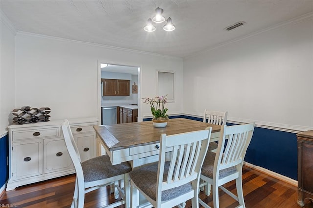 dining room with crown molding and dark wood-type flooring