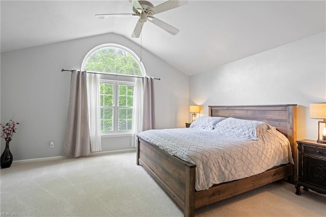 carpeted bedroom with multiple windows, vaulted ceiling, a ceiling fan, and baseboards