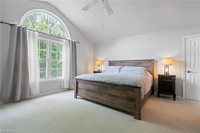 bedroom featuring lofted ceiling, light colored carpet, and a ceiling fan