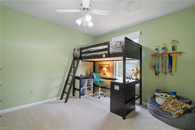 carpeted bedroom featuring baseboards and ceiling fan