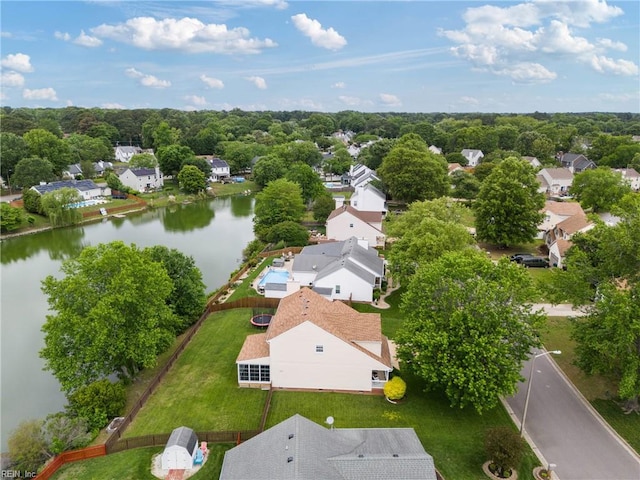 aerial view of residential area featuring a large body of water
