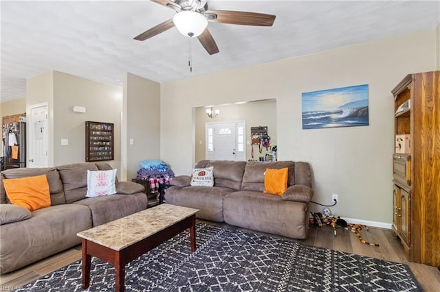 living area with wood finished floors, ceiling fan, and baseboards