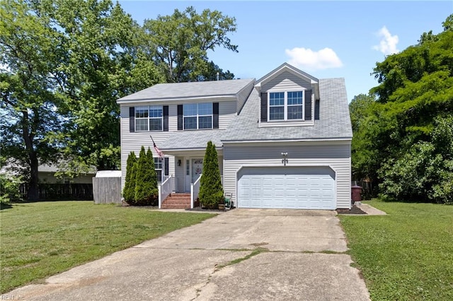 view of front of house with driveway, a front yard, and an attached garage