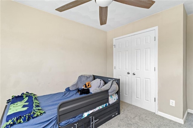 bedroom featuring carpet flooring, baseboards, a closet, and a ceiling fan
