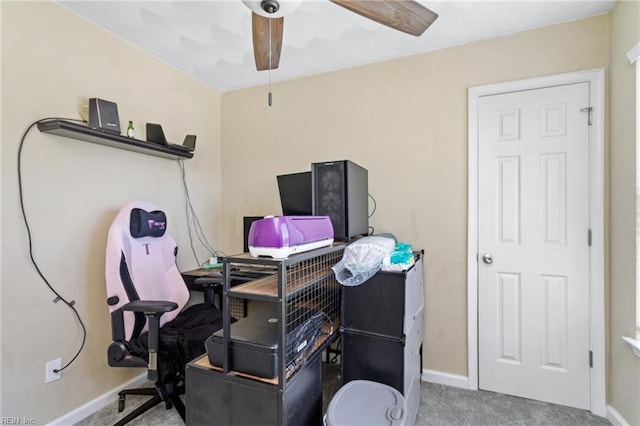 office space with carpet floors, a ceiling fan, and baseboards