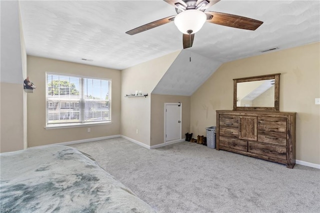 bedroom with carpet, baseboards, a ceiling fan, and lofted ceiling