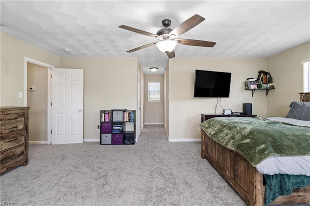 bedroom featuring baseboards, light carpet, and ceiling fan