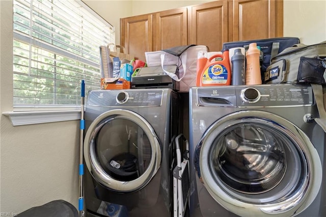 laundry area with cabinet space and washing machine and clothes dryer