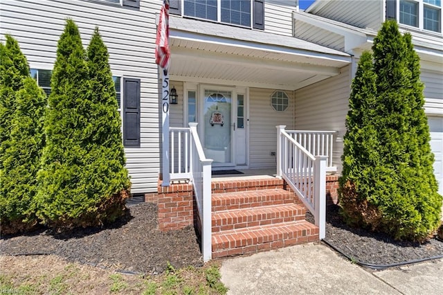 view of exterior entry with covered porch and crawl space