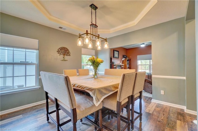 6884 Emerson Ln, Hayes, VA 23072 - dining room featuring a raised ceiling, dark wood-style floors, and baseboards