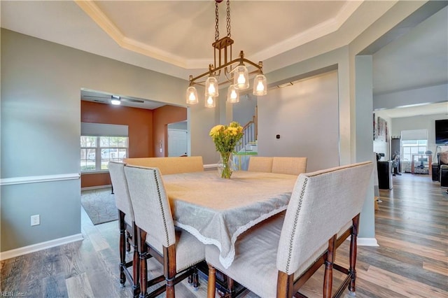 6884 Emerson Ln, Hayes, VA 23072 - dining room featuring wood finished floors, a raised ceiling, baseboards, and crown molding
