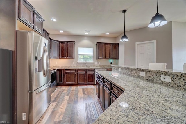 6884 Emerson Ln, Hayes, VA 23072 - kitchen featuring stainless steel fridge, a sink, light wood finished floors, light stone counters, and pendant lighting