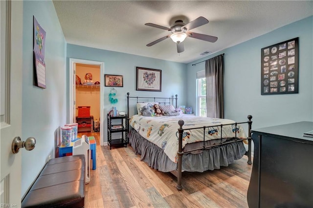 6884 Emerson Ln, Hayes, VA 23072 - bedroom featuring light wood finished floors, a ceiling fan, and a spacious closet