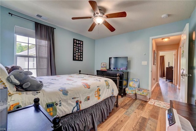 6884 Emerson Ln, Hayes, VA 23072 - bedroom with wood finished floors and ceiling fan